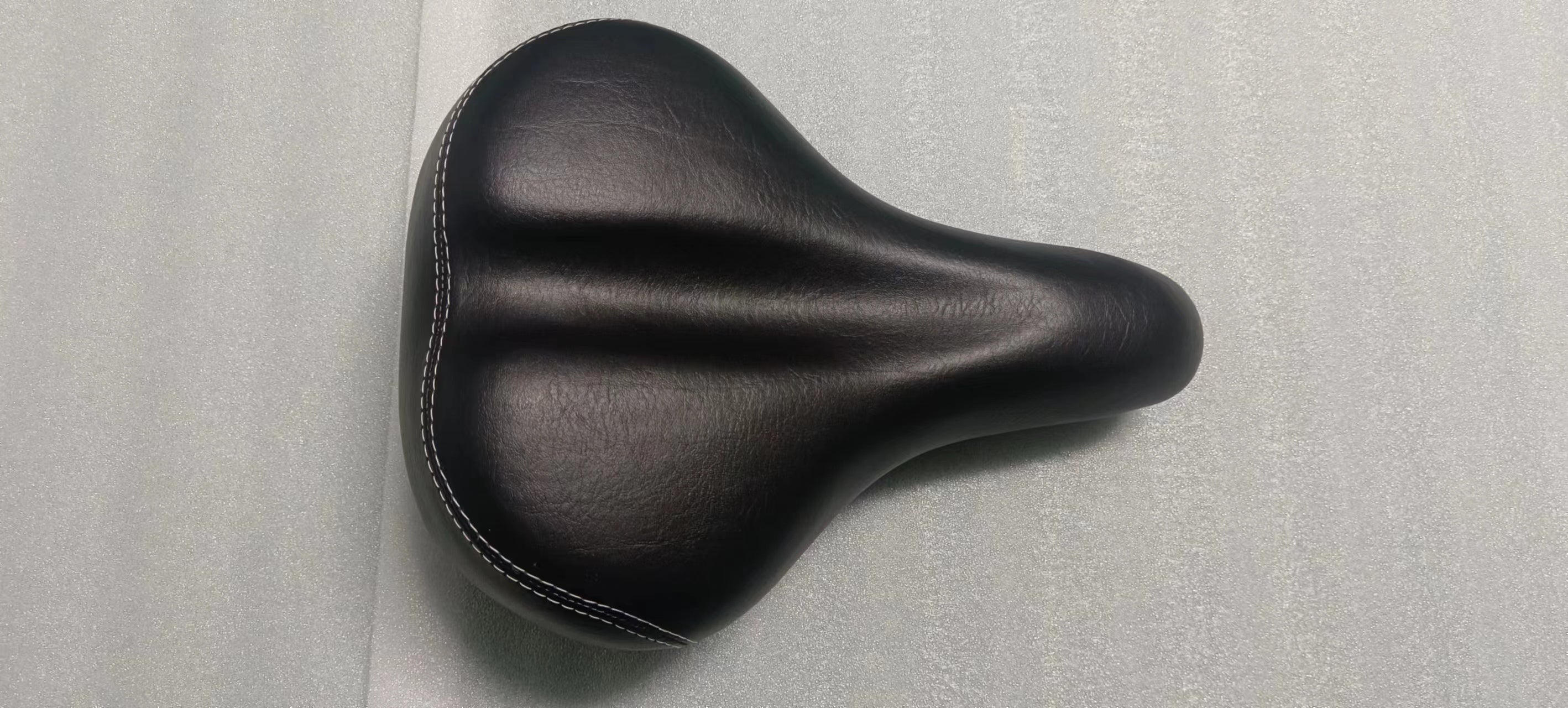 Comfortable brown saddle for LANKELEISI electric bike, showing a close-up view of the padded bike seat with mounting hardware.